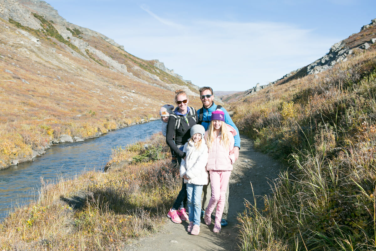 A family poses for a photo on a walking track