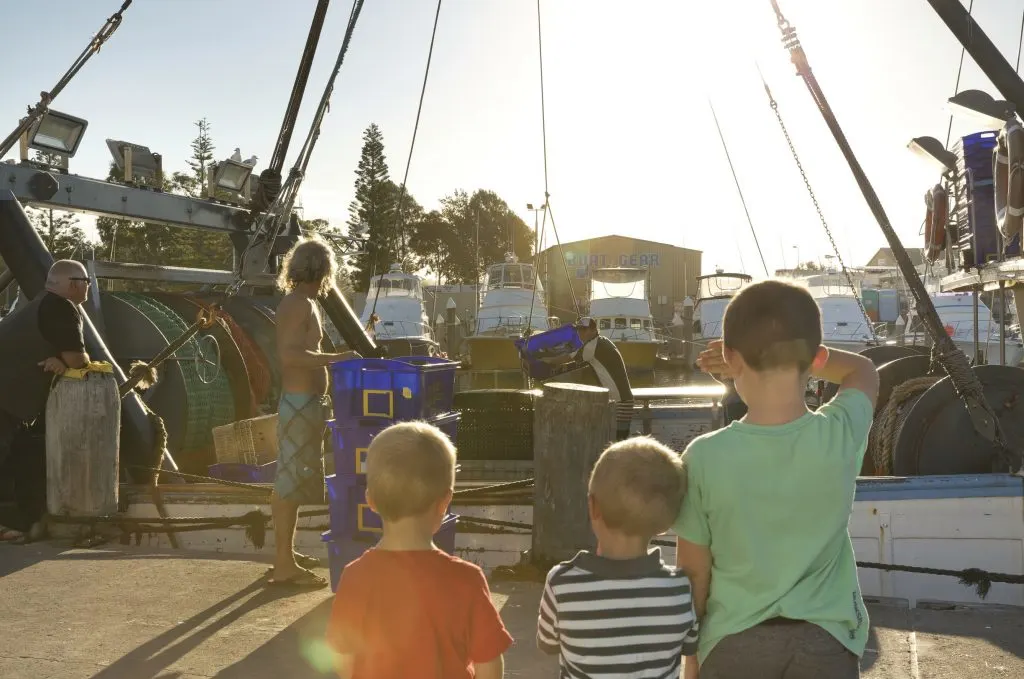 Kids watching fisherman pack their catch
