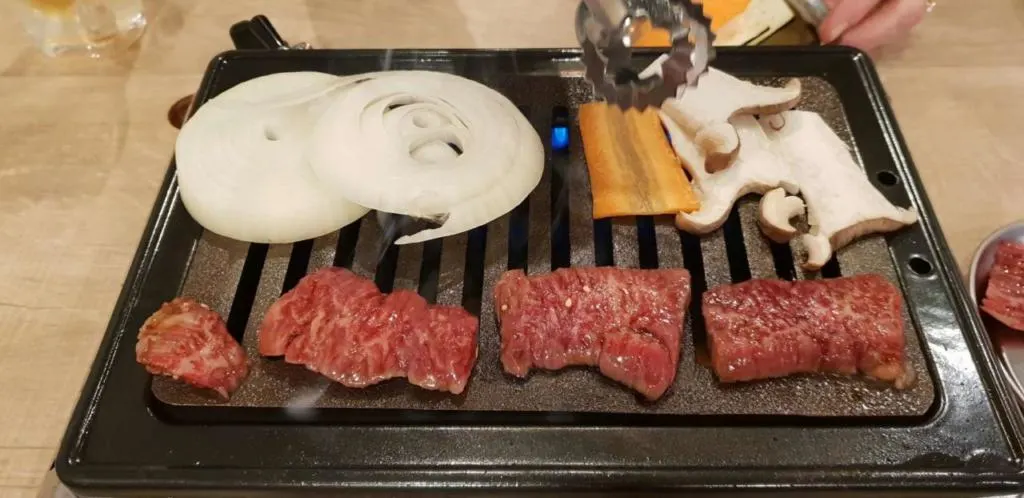 Thin slices of Wagu beef cooked at the table in Fukuoka.
