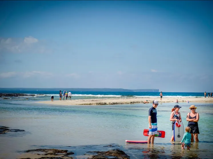 Family playing in Moona Moona Creek near Jervis Bay